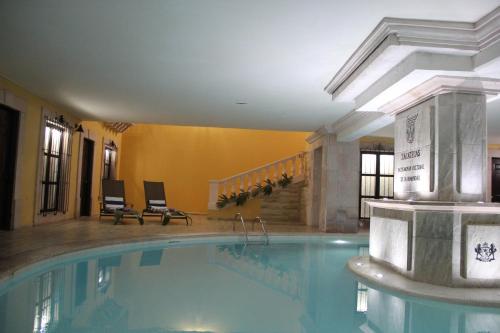 a large swimming pool in a hotel room at Meson de la Merced in Zacatecas