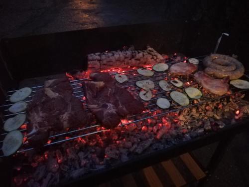 a grill with meat and other food on it at Casa Giampiero in Villaputzu