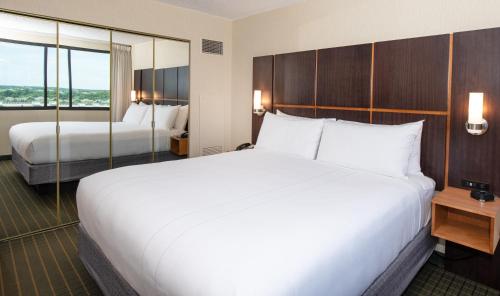 a hotel room with two beds and a window at NCED Conference Center & Hotel in Norman