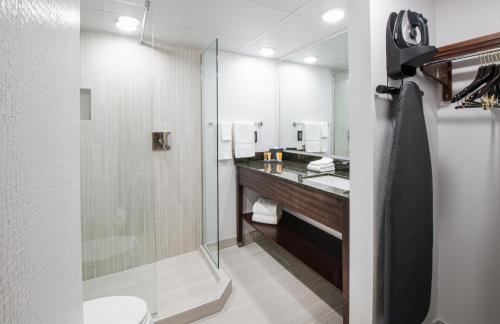 a bathroom with a shower and a toilet and a sink at NCED Conference Center & Hotel in Norman