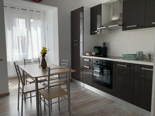 a kitchen with a table and chairs and a table and a kitchen at Modern Apartment Second Floor in Brussels