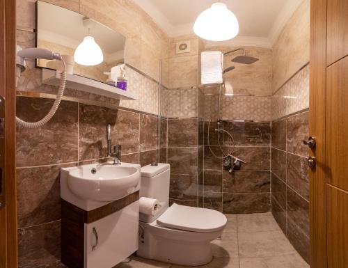 a bathroom with a toilet and a sink at La bella hotel in Istanbul