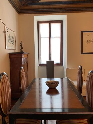 a dining room with a wooden table and chairs at Casa Rattazzi in Turin
