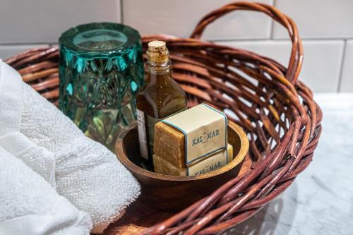 a bottle of alcohol and a candle in a basket at Casa Kalmar in Zipolite