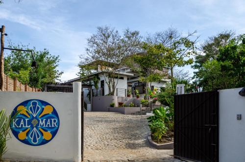 a house with a gate in front of it at Casa Kalmar in Zipolite