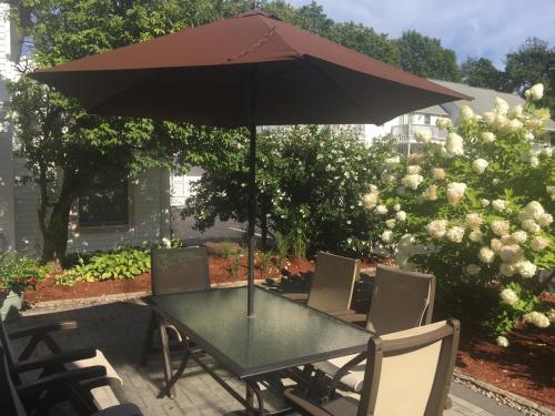 a table that has a umbrella on top of it at Pink Blossoms Resort in Ogunquit