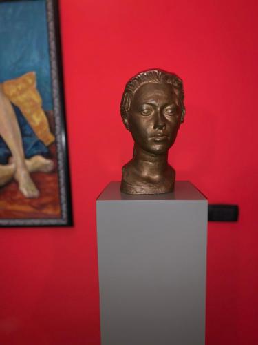 a bust of a woman on a table next to a painting at Casa Rattazzi in Turin