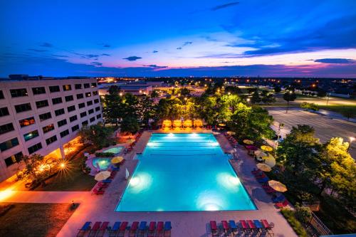an overhead view of a swimming pool at night at NCED Conference Center & Hotel in Norman