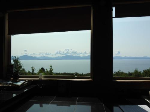 a bathroom with a large window with a view of the water at Alaska Adventure Cabins in Homer