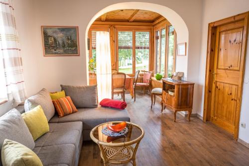 a living room with a couch and a table at Waldstrand Berger in Seeboden