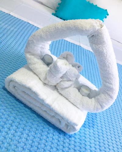 a stuffed animal sitting on top of a towel at Almira - rooms to let in Nea Roda