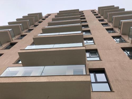 a tall building with many windows on it at Luxury Westpark 2 Presidentialsuite with Lake View W4 in Bucharest