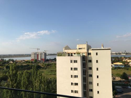 a tall white building with a city in the background at Luxury Westpark 2 Presidentialsuite with Lake View W4 in Bucharest
