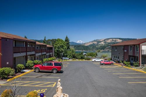 a parking lot with a red suv parked in it at Riverview Lodge in Hood River