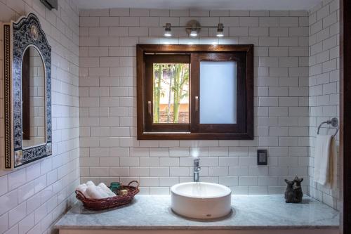 a white bathroom with a sink and a window at Casa Kalmar in Zipolite