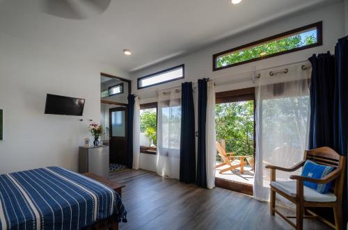 a bedroom with a bed and a sliding glass door at Casa Kalmar in Zipolite