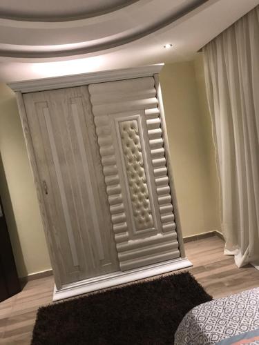 a wall with a door in a room at Cozy and Modern Apartment for Rent in Mohandessin in Cairo
