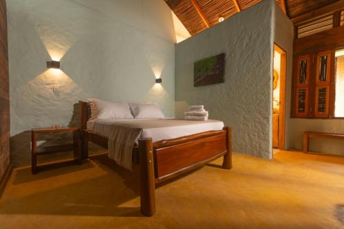 a bedroom with a bed in a room at Samadhi Ecohotel by Rotamundos in Puerto Escondido