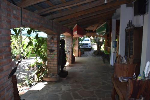 a brick hallway of a house with a brick wall at The Mayan Grouper in Suchitoto