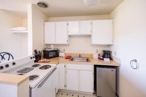 a kitchen with white cabinets and a sink at Riverview Lodge in Hood River