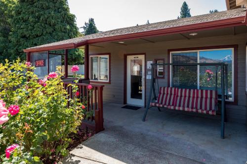 a bench on the porch of a house with flowers at Riverview Lodge in Hood River