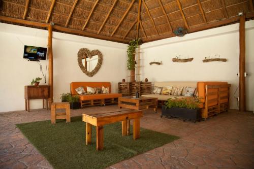 a living room with a couch and a table at Beautiful Private Villa for 16 PAX with garden, BBQ and pool, Playa del Carmen in Playa del Carmen