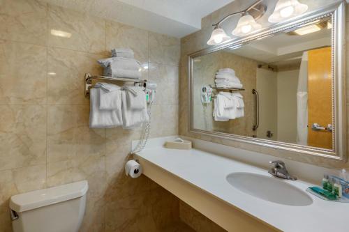 a bathroom with a sink and a toilet and a mirror at Atlantic Beach Hotel Newport in Middletown
