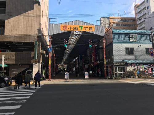 a city street with people crossing the street with a green traffic light at momo premium 401 in Sapporo