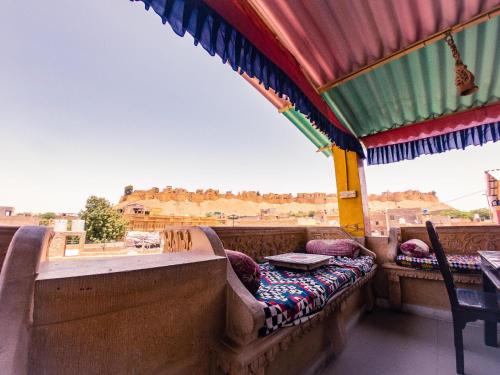 a balcony with a bed and a view of a city at Hotel Tokyo Palace in Jaisalmer