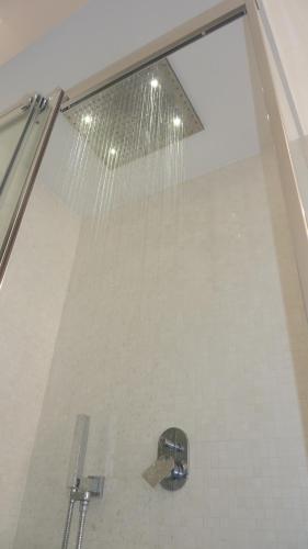 a shower with a glass window and a sink at Al Pergolesi B&B in Iesi