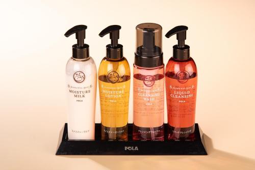 a group of four bottles of hair products on a shelf at Ishinoya Izunagaoka - TKP Hotels & Resorts in Izunokuni