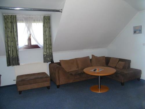 a living room with a couch and a table at Hotel Restauracja Tawerna Gliwice in Gliwice