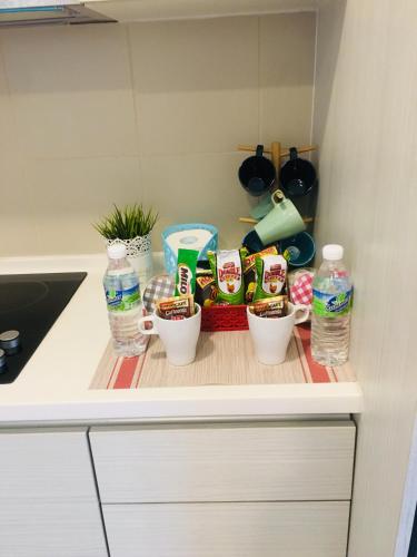 a kitchen counter with some food and bottles of water at Studio I-Soho D'Gunduls Homestay by DGH I-CITY in Shah Alam