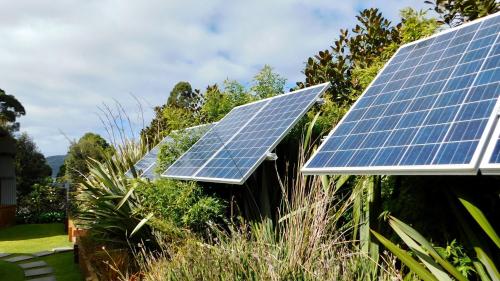 a group of solar panels on the side of a house at 43 Degrees Bruny Island in Adventure Bay