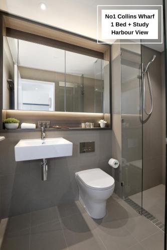 a bathroom with a toilet and a sink and a shower at Orange Stay at Collins Wharf in Melbourne