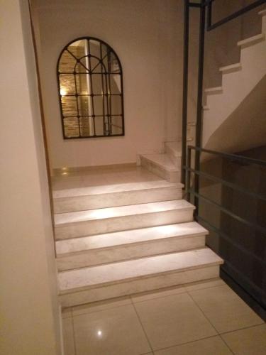 a set of stairs in a room with a window at RITSA APARTMENT in Perea
