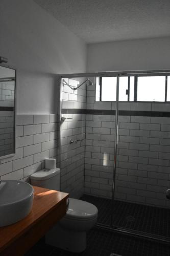 a bathroom with a toilet and a sink and a shower at Ballina Homestead Motel in Ballina