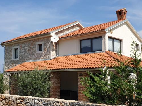 a house with an orange tiled roof at Villa Kvarner in Krk