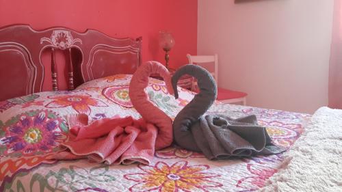 una cama con dos cisnes hechos de toallas en Chez Yannick et Isabelle, en Saint-Nazaire