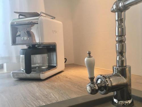 a coffee maker sitting on a counter next to a mixer at Apartmenthaus Lütt Meer in Ludorf