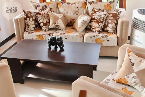 a coffee table in a living room with a couch at Villa 252 Kosgoda in Kosgoda