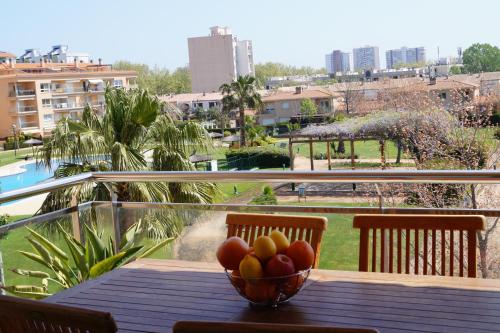 a bowl of fruit on a table on a balcony at LE Y LE Platja d'Aro in Platja d'Aro