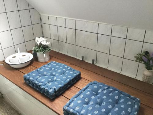 two blue ottoman cushions sitting on a wooden table at Bed & Breakfast v/Pia Sørensen in Fredericia