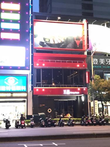 a group of motorcycles parked in front of a building at Long Siang Hotel in Kaohsiung