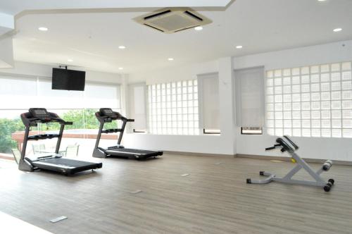 a gym with three exercise bikes in a room at Mulia Hotel in Bandar Seri Begawan