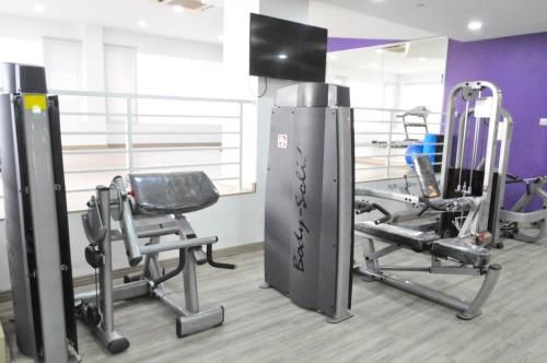 a gym with several treadmills and machines at Mulia Hotel in Bandar Seri Begawan