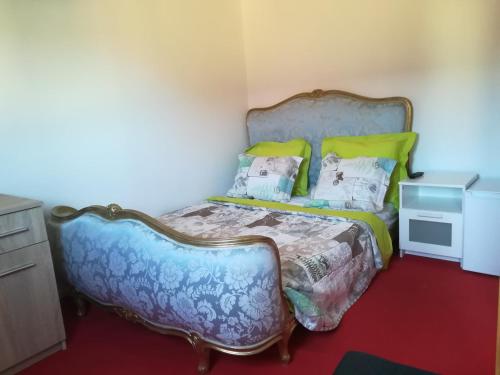 a bedroom with a bed with a blue bedspread and pillows at Peace in Corbeil-Essonnes