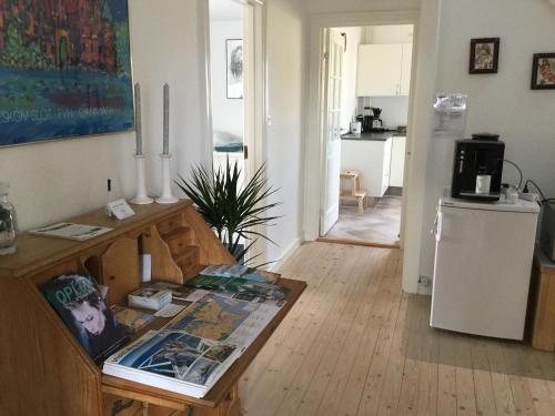 a living room with a table and a kitchen at Bed & Breakfast v/Pia Sørensen in Fredericia