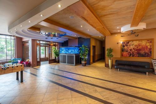 a large living room with a large aquarium at Hotel Badura in Wadowice