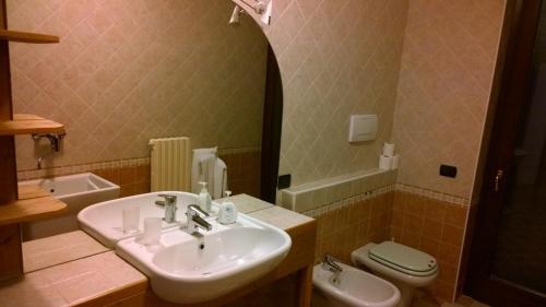 a bathroom with a sink and a toilet at Ca' Del Sasso in Verona